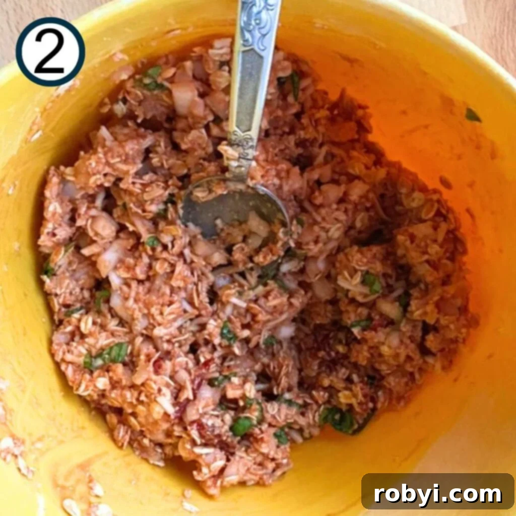 Wet ingredients (ketchup and egg) added to the dry mix in a large bowl.