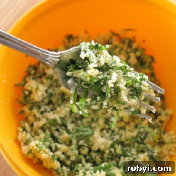 Aromatic Herb-Roasted Pork Tenderloin 3 Close-up of Parmesan Herb Breading mixture on a fork, showing texture and fresh herbs