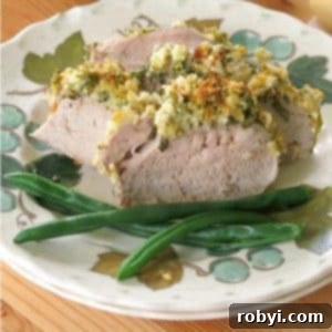 Aromatic Herb-Roasted Pork Tenderloin 6 Sliced Herb Crusted Pork Tenderloin on plate with green beans