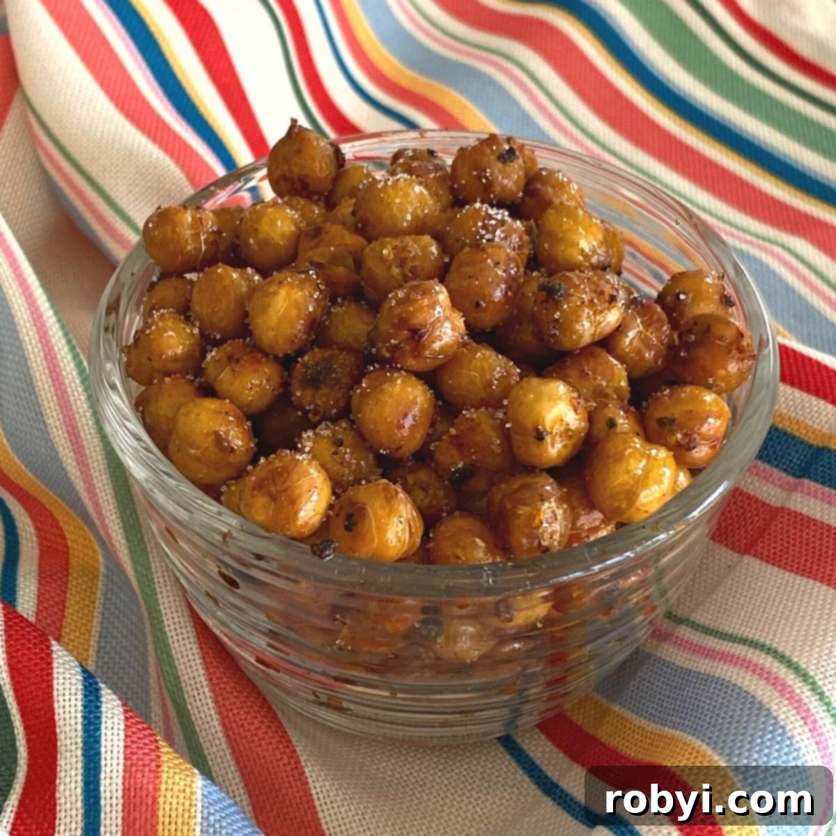 Sweet and spicy roasted chickpeas in a glass bowl, ready to be enjoyed.