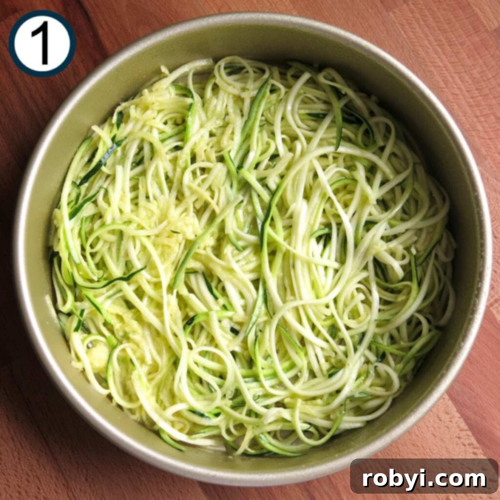 Naked Zucchini Noodle Tart 4 Spiralized zucchini noodles mixed with egg and olive oil, forming the base in a greased 9-inch round baking dish.