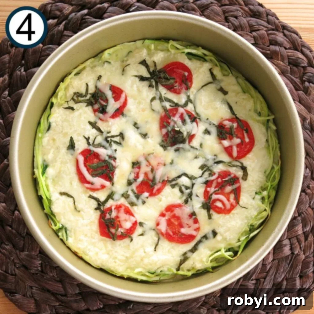 Naked Zucchini Noodle Tart 7 A perfectly baked, golden-brown crustless zucchini pie, still in its circular baking pan, ready to be sliced and served.