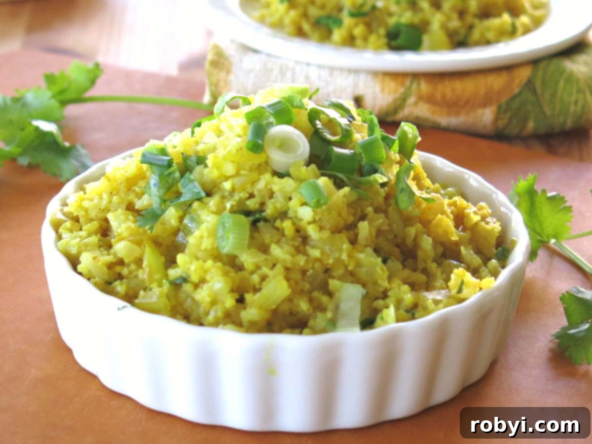 Cooked curry cauliflower rice recipe in a large bowl, ready to be served or portioned for meal prep.