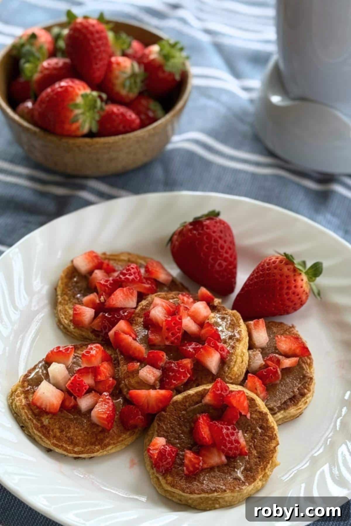 Oat cottage cheese pancakes with almond butter and strawberries